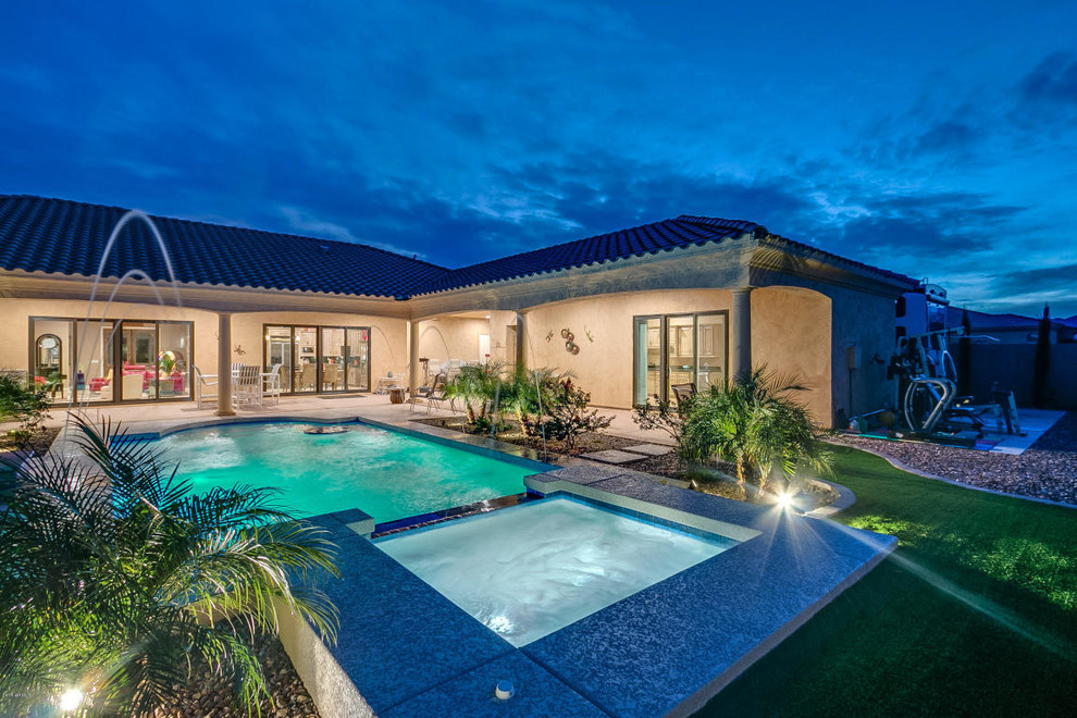 Example of a large transitional backyard concrete and rectangular lap pool fountain design in Phoenix
