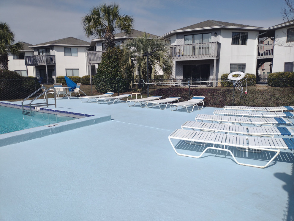 Inspiration for a large coastal courtyard concrete and rectangular lap pool remodel in Miami