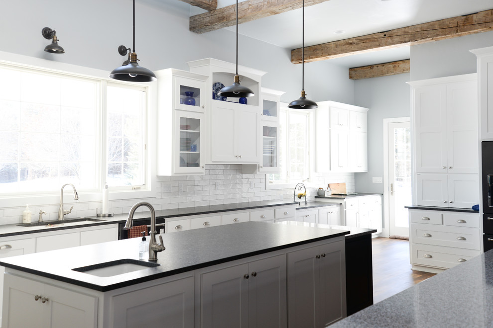 Vinyl floor and brown floor kitchen photo with recessed-panel cabinets, white cabinets, white backsplash and ceramic backsplash
