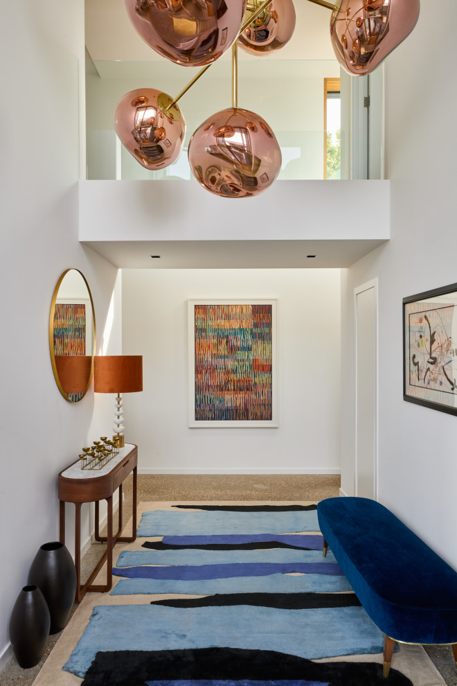 Inspiration for an expansive contemporary hallway in Channel Islands with white walls, concrete flooring and grey floors.