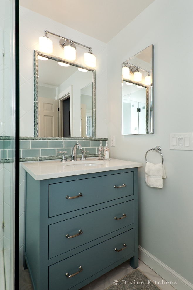 Inspiration for a small traditional master bathroom in Boston with an undermount sink, raised-panel cabinets, blue cabinets, engineered quartz benchtops, a corner shower, a two-piece toilet, multi-coloured tile, ceramic tile, multi-coloured walls and ceramic floors.