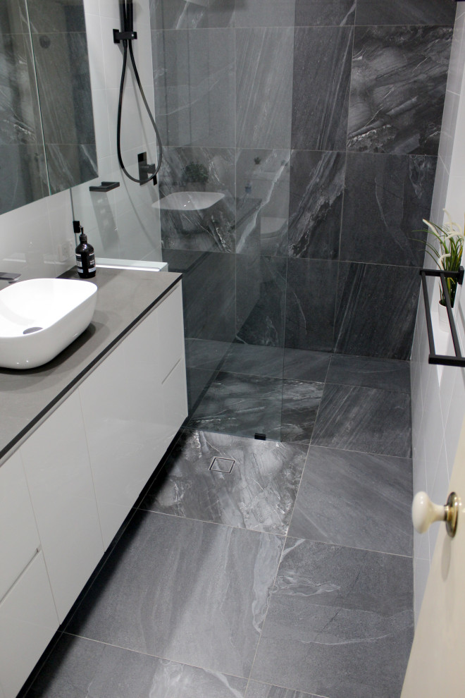 Design ideas for a small modern master bathroom in Perth with flat-panel cabinets, white cabinets, an open shower, a one-piece toilet, white tile, ceramic tile, black walls, porcelain floors, a vessel sink, engineered quartz benchtops, grey floor, an open shower and grey benchtops.