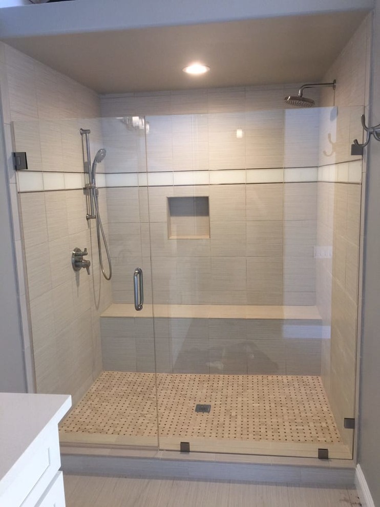 Inspiration for a mid-sized transitional 3/4 bathroom in Los Angeles with recessed-panel cabinets, white cabinets, an alcove shower, gray tile, porcelain tile, grey walls, porcelain floors, engineered quartz benchtops, grey floor and a hinged shower door.