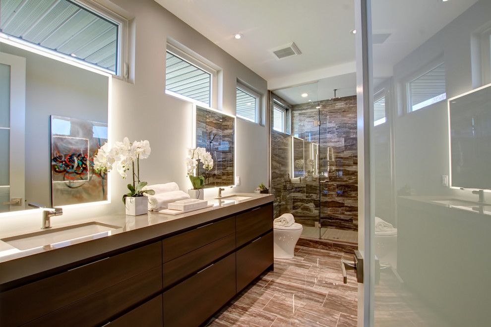 Mid-sized contemporary 3/4 bathroom in Toronto with flat-panel cabinets, dark wood cabinets, an alcove shower, a one-piece toilet, brown tile, porcelain tile, brown walls, porcelain floors, an undermount sink, quartzite benchtops, brown floor, a hinged shower door and beige benchtops.