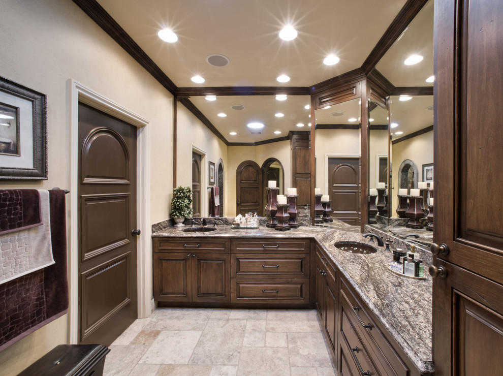 Inspiration for a large traditional master bathroom in Los Angeles with an undermount sink, recessed-panel cabinets, dark wood cabinets, granite benchtops, beige walls, multi-coloured tile, stone slab and multi-coloured benchtops.