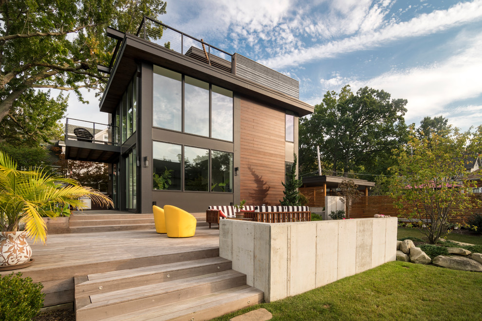 Small modern two-storey grey house exterior in Cleveland with wood siding and a flat roof.