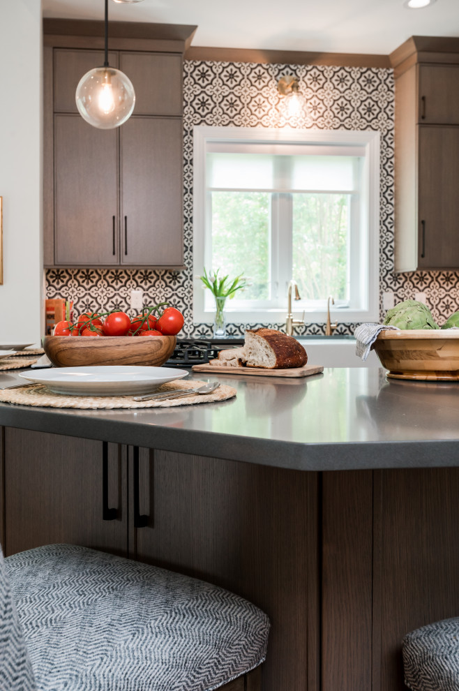 Example of a tuscan medium tone wood floor eat-in kitchen design in Baltimore with light wood cabinets, multicolored backsplash, cement tile backsplash, stainless steel appliances, an island and gray countertops