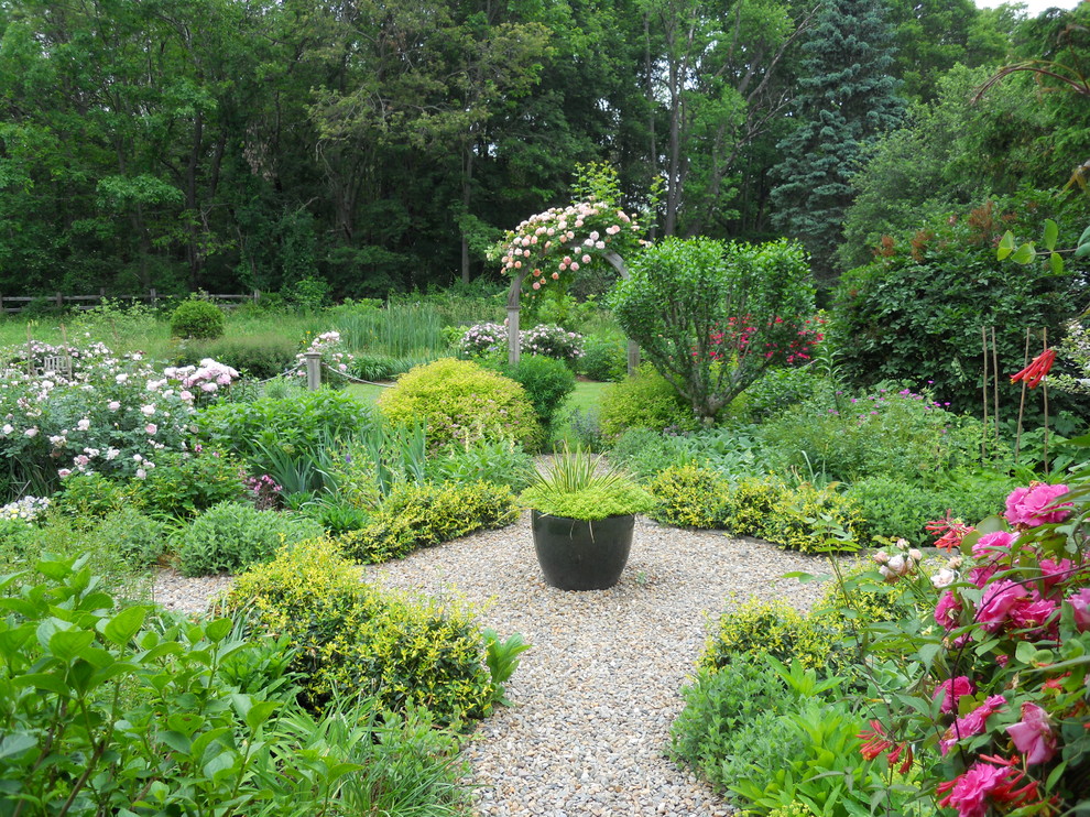 Mid-sized country front yard full sun formal garden in Providence with a garden path and gravel.
