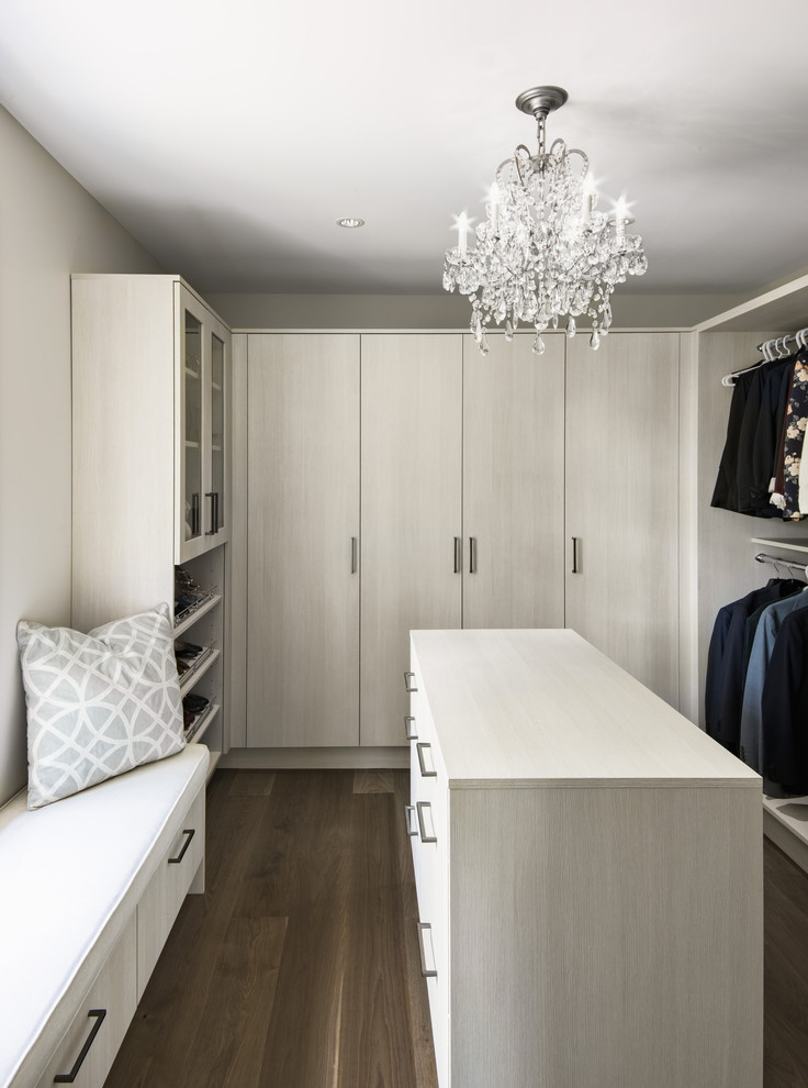 Photo of a contemporary gender-neutral walk-in wardrobe in Ottawa with flat-panel cabinets, light wood cabinets, dark hardwood floors and brown floor.