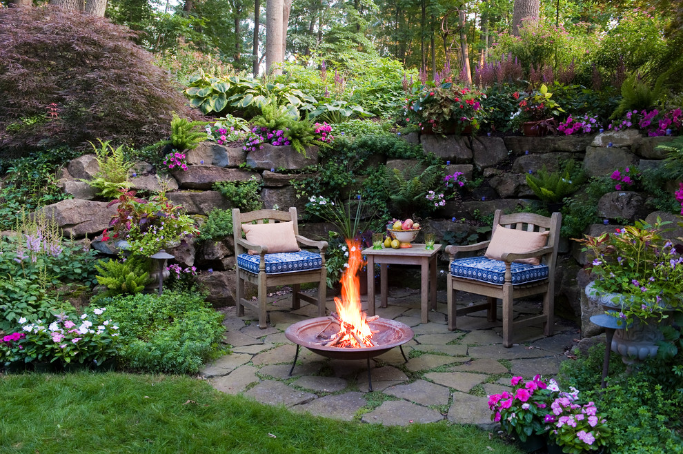 Photo of a traditional backyard patio in Philadelphia with a fire feature, natural stone pavers and no cover.