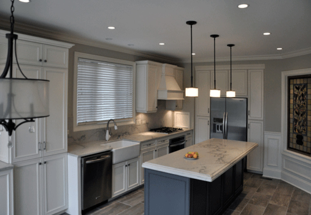 Enclosed kitchen - mid-sized transitional u-shaped porcelain tile enclosed kitchen idea in Chicago with a farmhouse sink, recessed-panel cabinets, white cabinets, marble countertops, gray backsplash, stainless steel appliances and an island