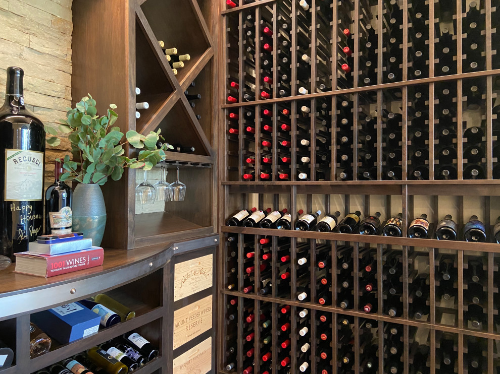 Example of a large transitional wine cellar design in San Diego with storage racks