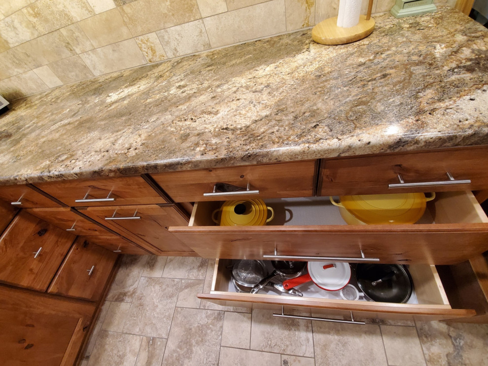 Inspiration for a small transitional porcelain tile and beige floor kitchen remodel with an undermount sink, recessed-panel cabinets, brown cabinets, laminate countertops, beige backsplash, porcelain backsplash, stainless steel appliances, no island and brown countertops