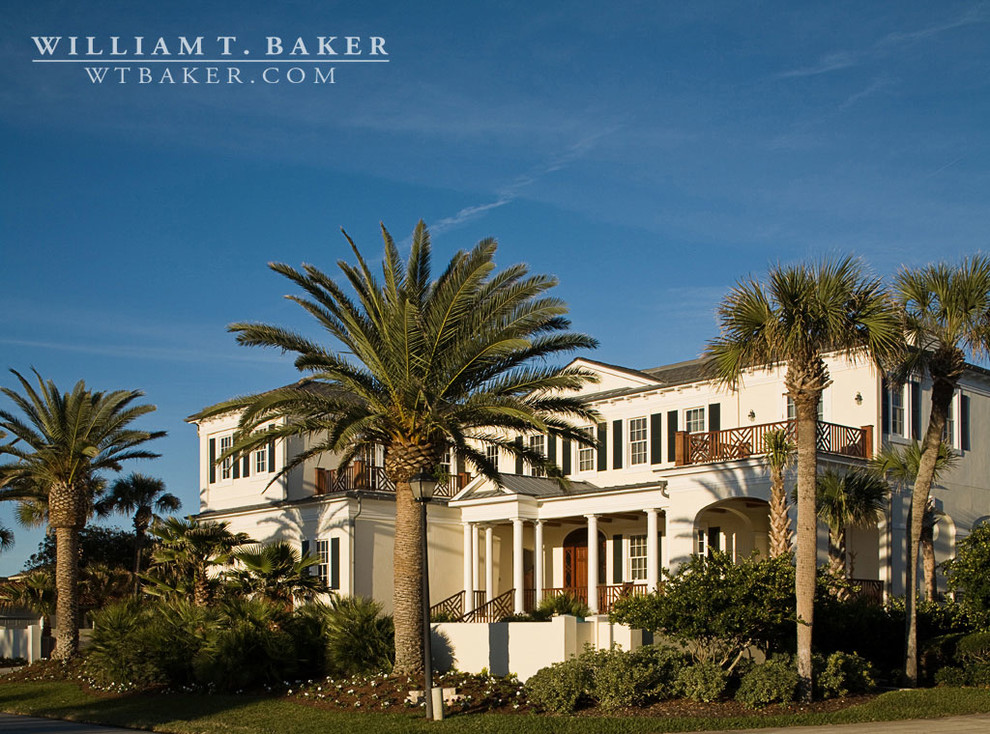 This is an example of an expansive beach style two-storey stucco white exterior in Atlanta with a hip roof.