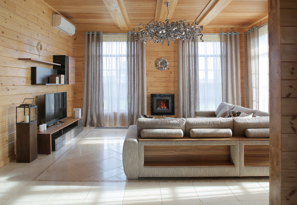 This is an example of a mid-sized country open concept living room in Moscow with a library, beige walls, porcelain floors, a wall-mounted tv and grey floor.