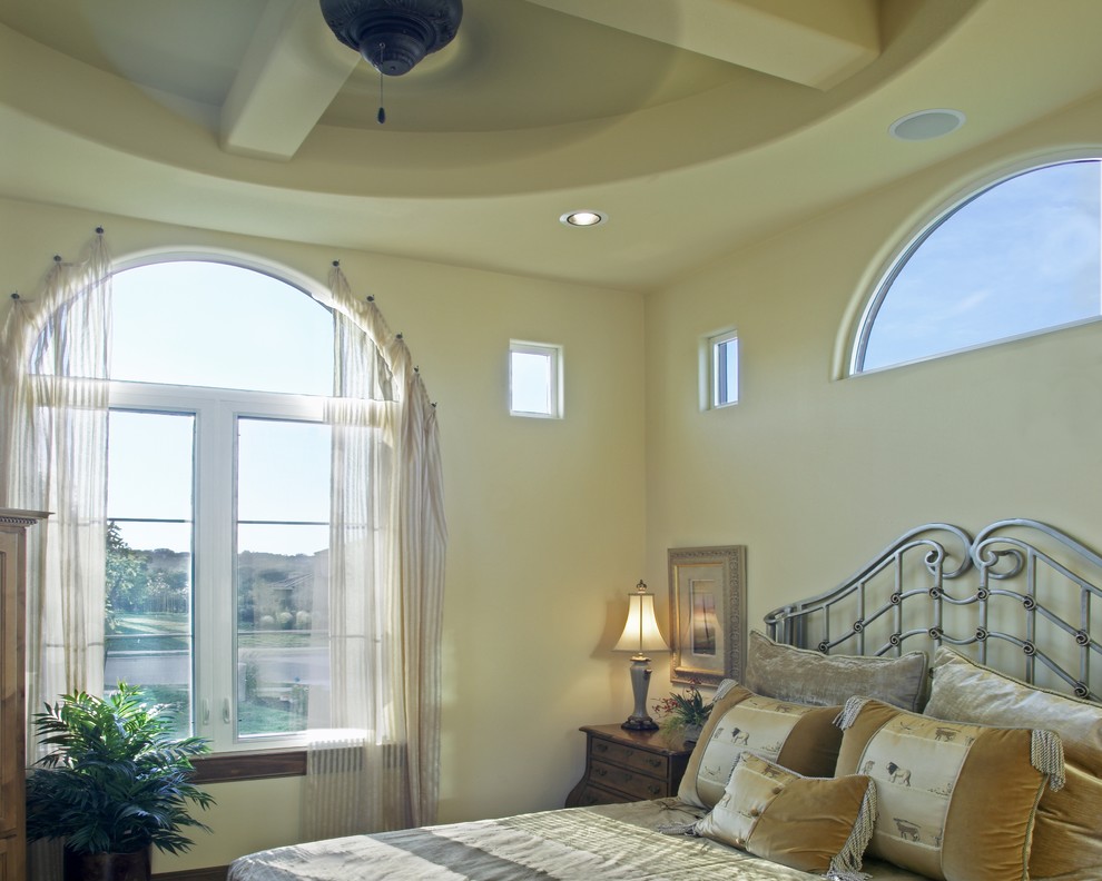 Inspiration for a mediterranean bedroom in Austin with beige walls.