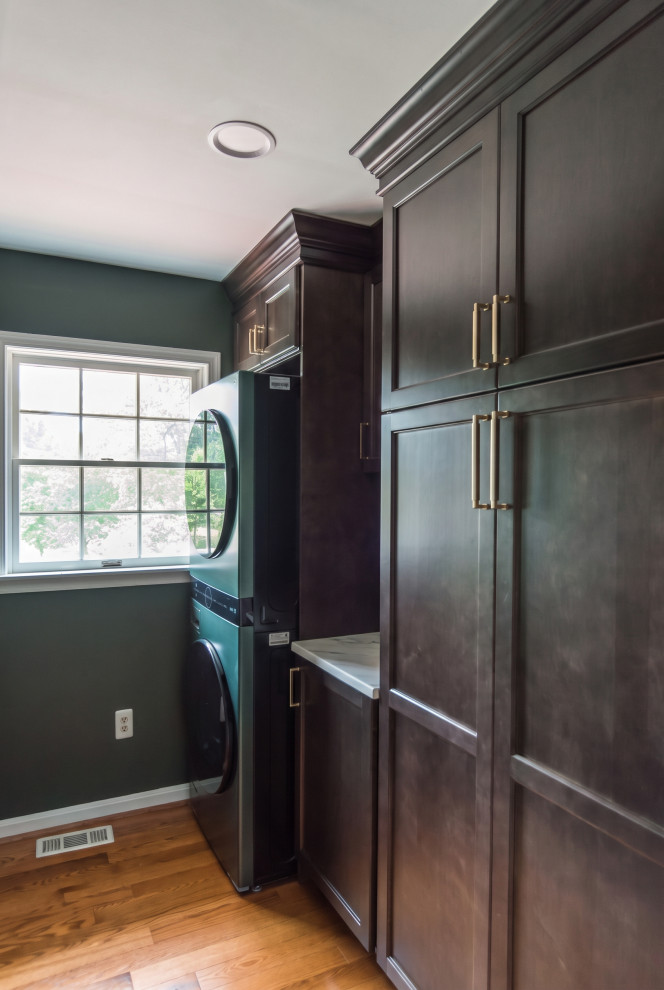 Custom Dark‑Wood Laundry Room with Stacked Washer & Dryer