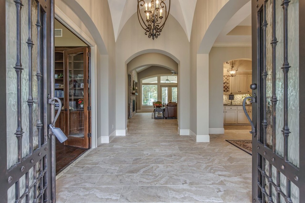 Design ideas for a mid-sized foyer in Houston with beige walls, limestone floors, a double front door and a metal front door.