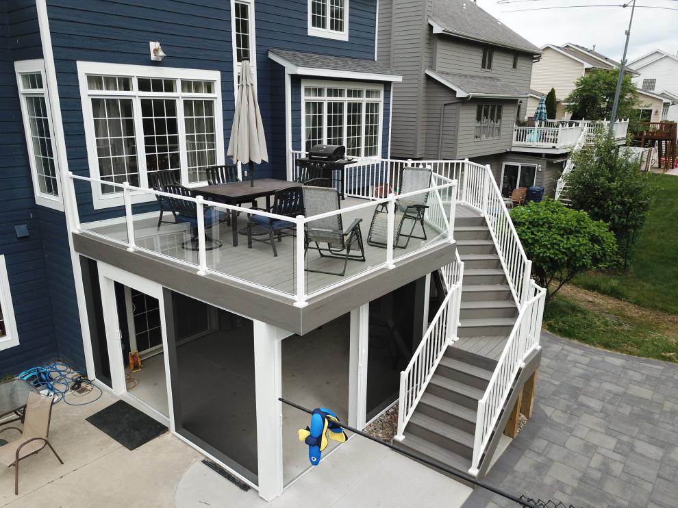 Design ideas for a mid-sized modern backyard and first floor deck in Other with no cover and glass railing.