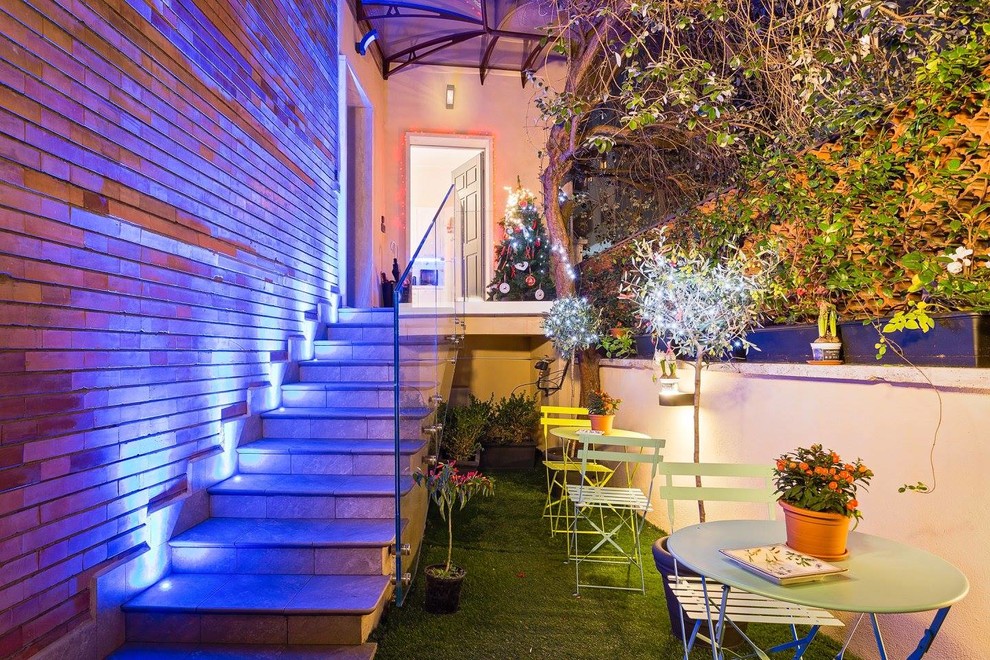 Small industrial courtyard formal garden in Rome with natural stone pavers.