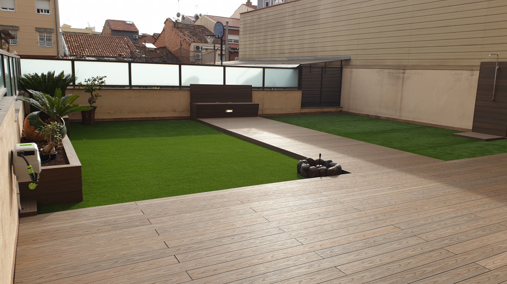 This is an example of an expansive modern backyard deck in Other with a water feature and no cover.