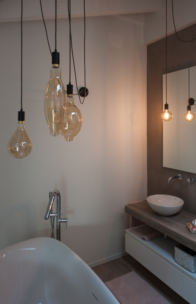 Inspiration for a mid-sized industrial master bathroom in Other with glass-front cabinets, white cabinets, an alcove tub, a two-piece toilet, brown walls, porcelain floors, a vessel sink, laminate benchtops, brown floor and brown benchtops.