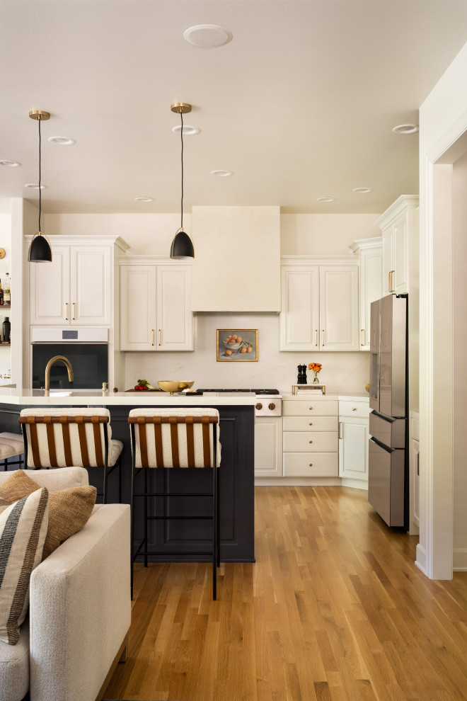 Eat-in kitchen - mid-sized transitional l-shaped eat-in kitchen idea in Portland with shaker cabinets, white cabinets, quartzite countertops, white backsplash, an island and white countertops