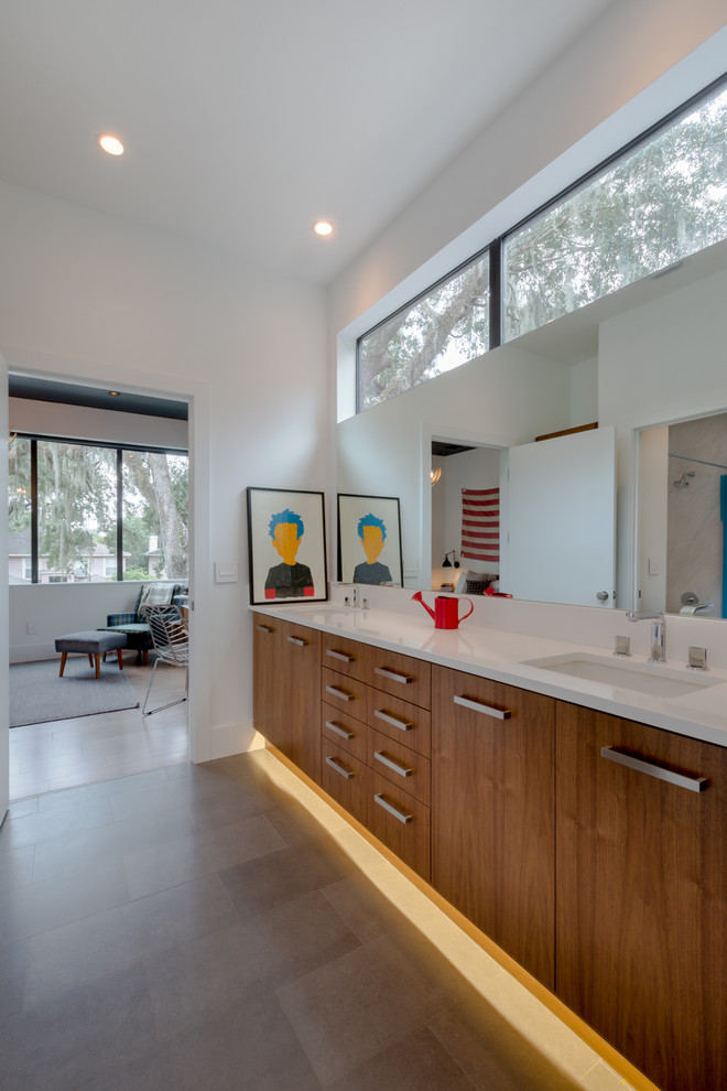 Contemporary bathroom in Orlando with an undermount sink, flat-panel cabinets, medium wood cabinets, engineered quartz benchtops, white walls and ceramic floors.