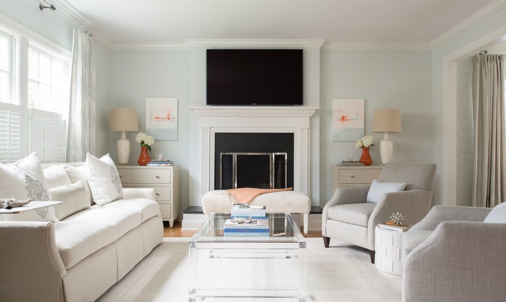 Mid-sized transitional formal enclosed living room in DC Metro with blue walls, medium hardwood floors, a standard fireplace, a plaster fireplace surround and a wall-mounted tv.