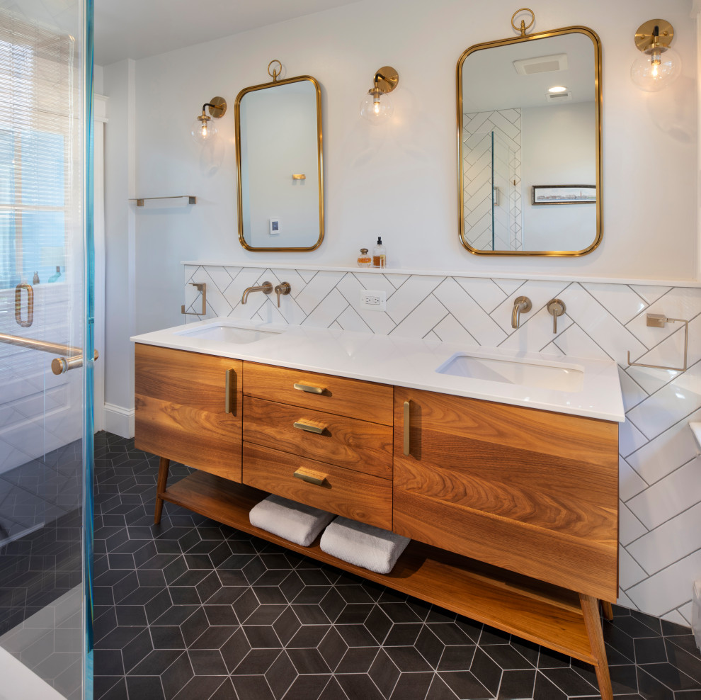 Inspiration for a mid-sized midcentury master bathroom in DC Metro with flat-panel cabinets, medium wood cabinets, a double shower, white tile, ceramic tile, white walls, ceramic floors, an undermount sink, engineered quartz benchtops, black floor, a hinged shower door, white benchtops, a shower seat, a double vanity and a freestanding vanity.