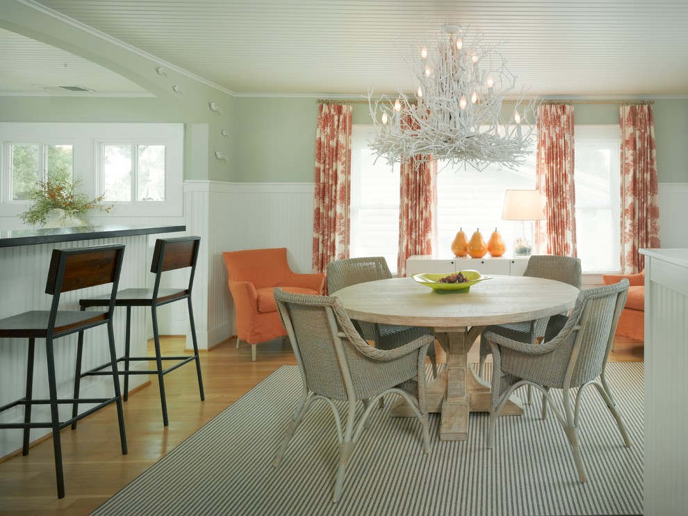 This is an example of a beach style dining room in San Francisco with green walls.
