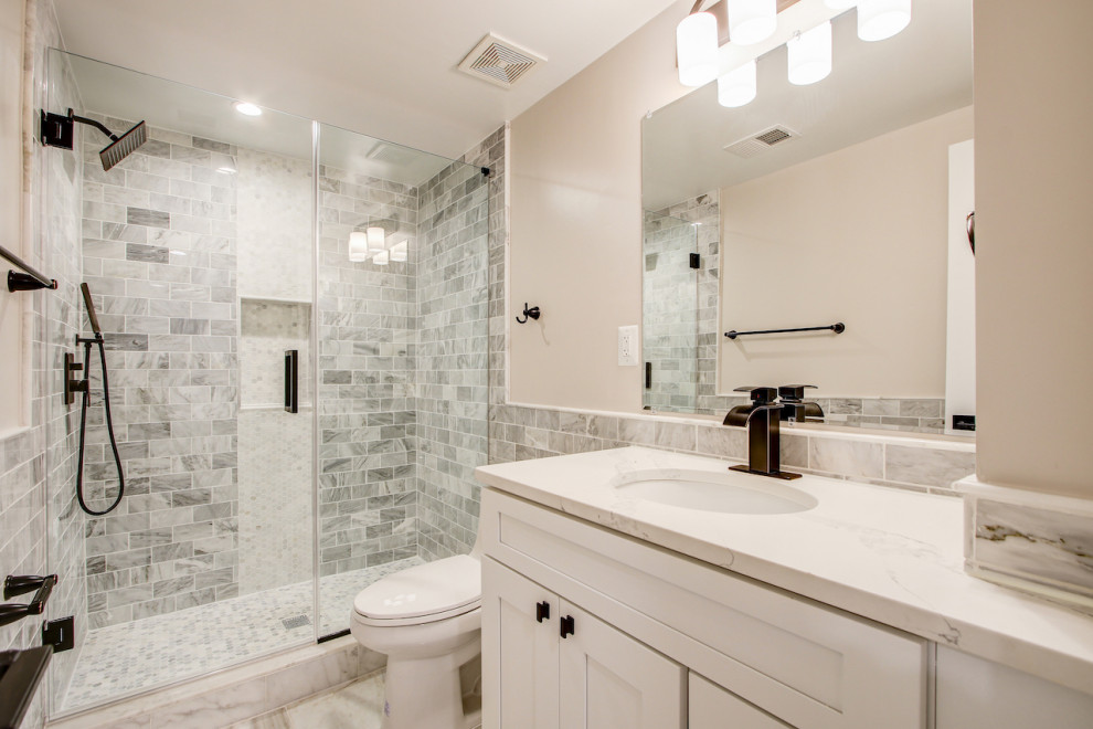 Photo of a medium sized contemporary shower room bathroom in DC Metro with shaker cabinets, white cabinets, a built-in bath, a shower/bath combination, a one-piece toilet, beige tiles, stone tiles, beige walls, a built-in sink, quartz worktops, a shower curtain, white worktops, a single sink and a freestanding vanity unit.