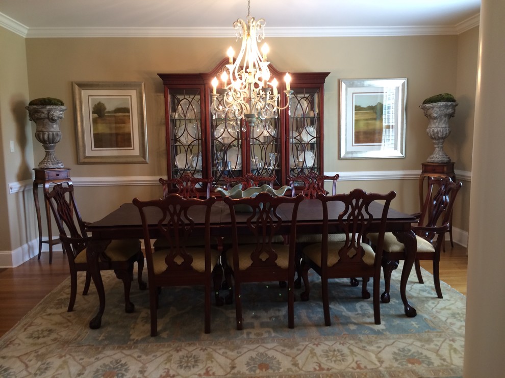 Mid-sized transitional medium tone wood floor dining room photo with beige walls