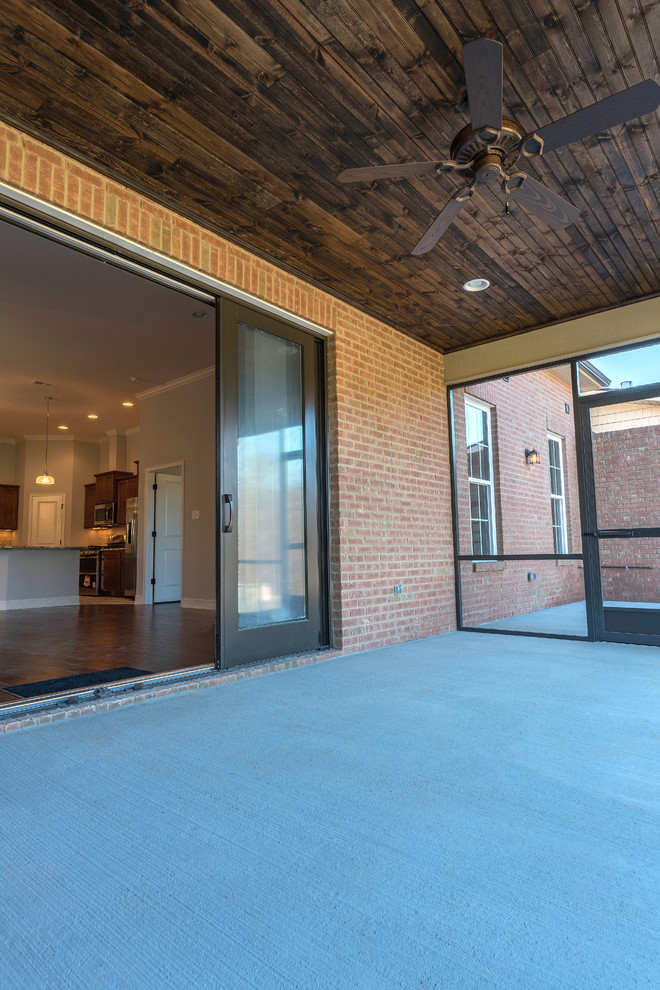 Inspiration for a mid-sized transitional concrete screened-in back porch remodel with a roof extension