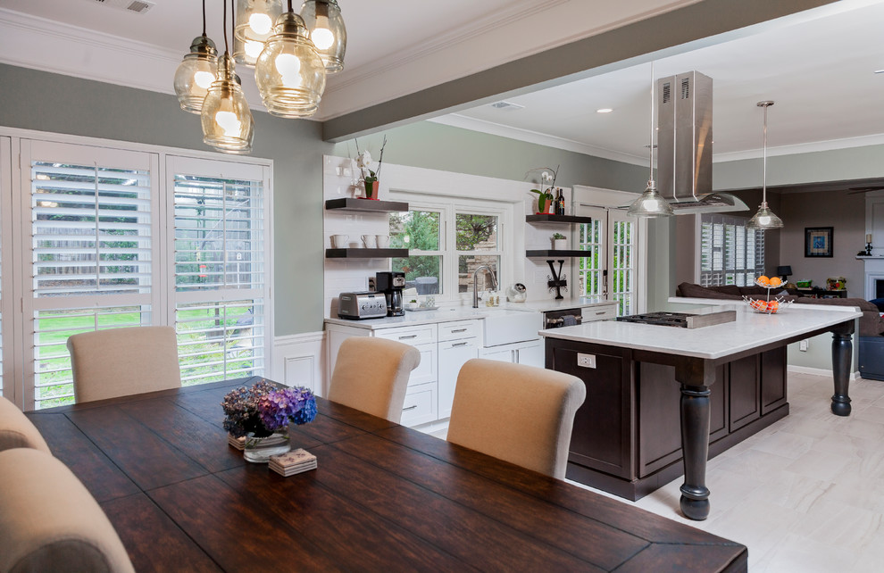 This is an example of an expansive contemporary kitchen in Atlanta with a farmhouse sink, shaker cabinets, white cabinets, quartz benchtops, white splashback, ceramic splashback, stainless steel appliances, porcelain floors, with island, beige floor and white benchtop.