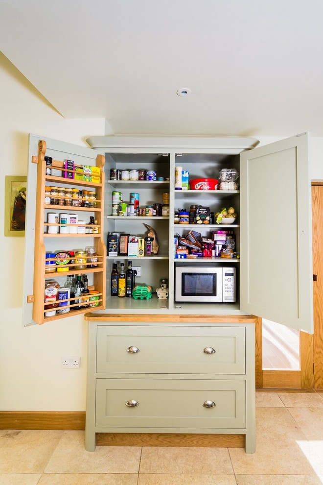 Design ideas for a large traditional l-shaped kitchen/diner in Oxfordshire with a double-bowl sink, shaker cabinets, green cabinets, granite worktops, grey splashback, stone tiled splashback, stainless steel appliances, limestone flooring and an island.