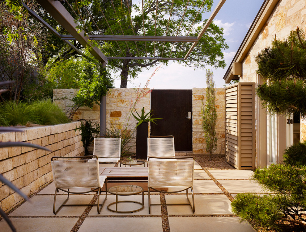 Design ideas for a midcentury side yard patio in Austin with a pergola.