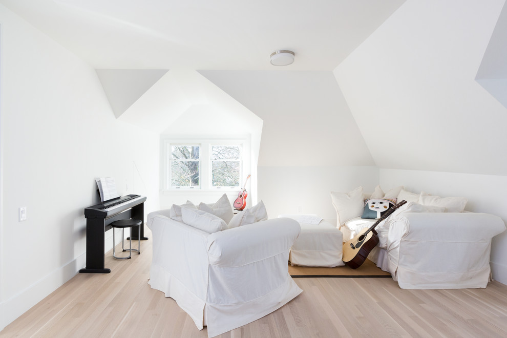 This is an example of a mid-sized transitional gender-neutral kids' room in Vancouver with white walls and light hardwood floors.