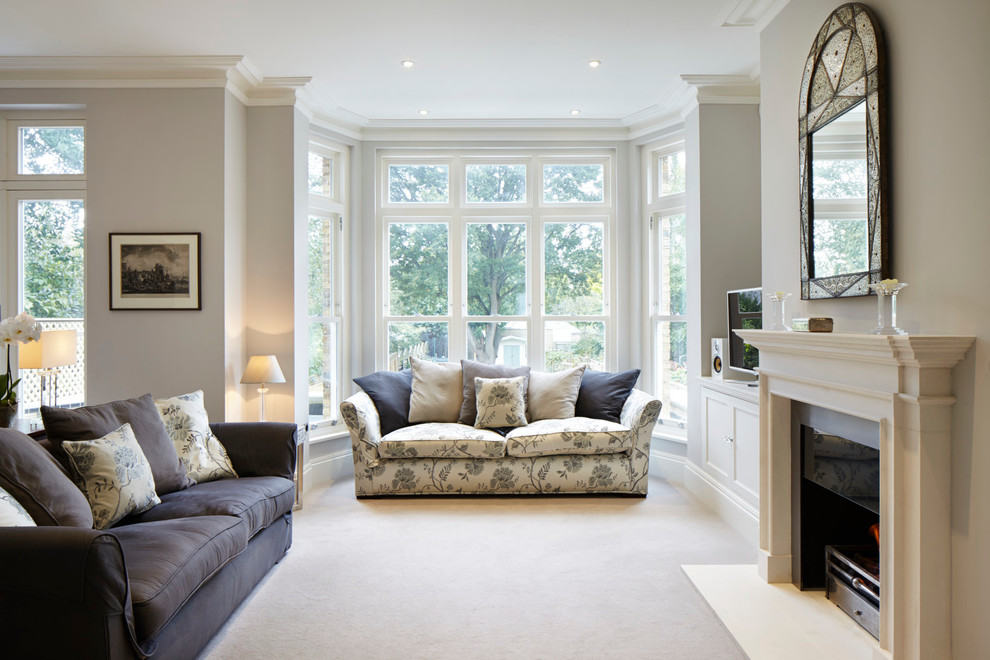 Traditional living room in London with a standard fireplace, grey walls and carpet.