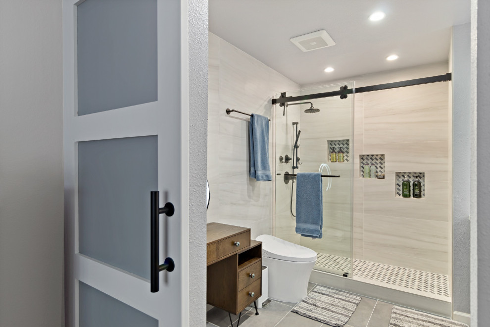 Inspiration for a medium sized modern ensuite bathroom in San Francisco with shaker cabinets, blue cabinets, a double shower, a bidet, beige tiles, wood-effect tiles, white walls, porcelain flooring, a submerged sink, quartz worktops, grey floors, a hinged door, white worktops, a wall niche, double sinks and a built in vanity unit.