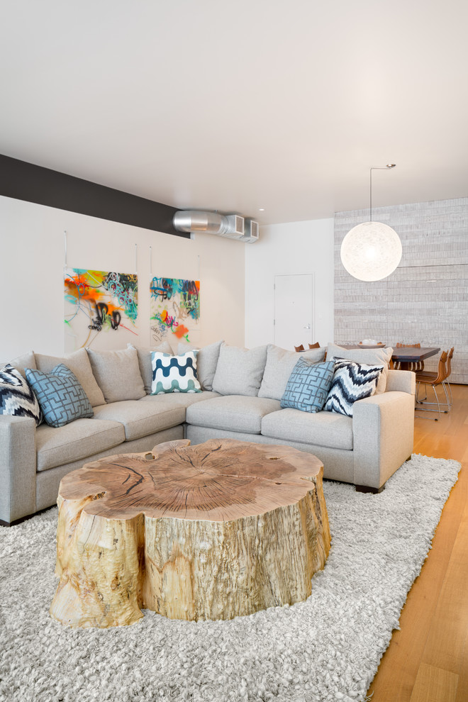 This is an example of a contemporary open concept living room in Portland with white walls.