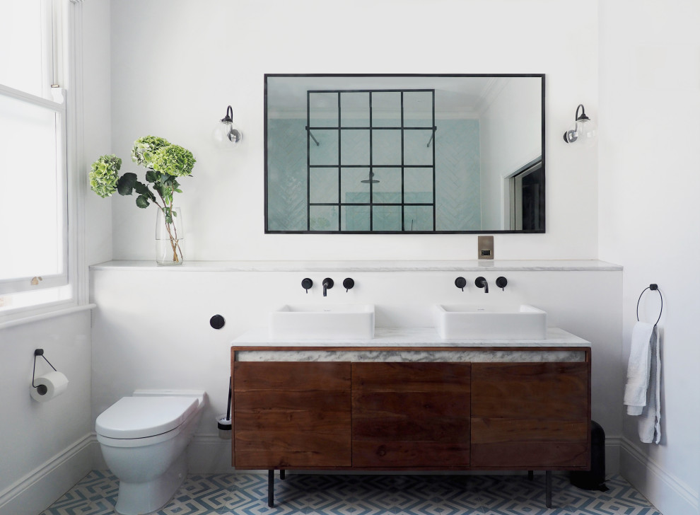 Inspiration for a transitional master bathroom in London with dark wood cabinets, white walls, a vessel sink, multi-coloured floor, white benchtops, a double vanity, a freestanding vanity and flat-panel cabinets.