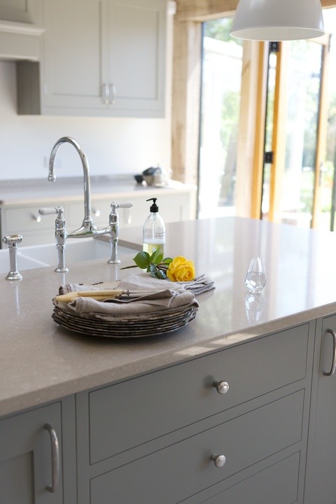 This is an example of a contemporary open plan kitchen in Sussex with an island.