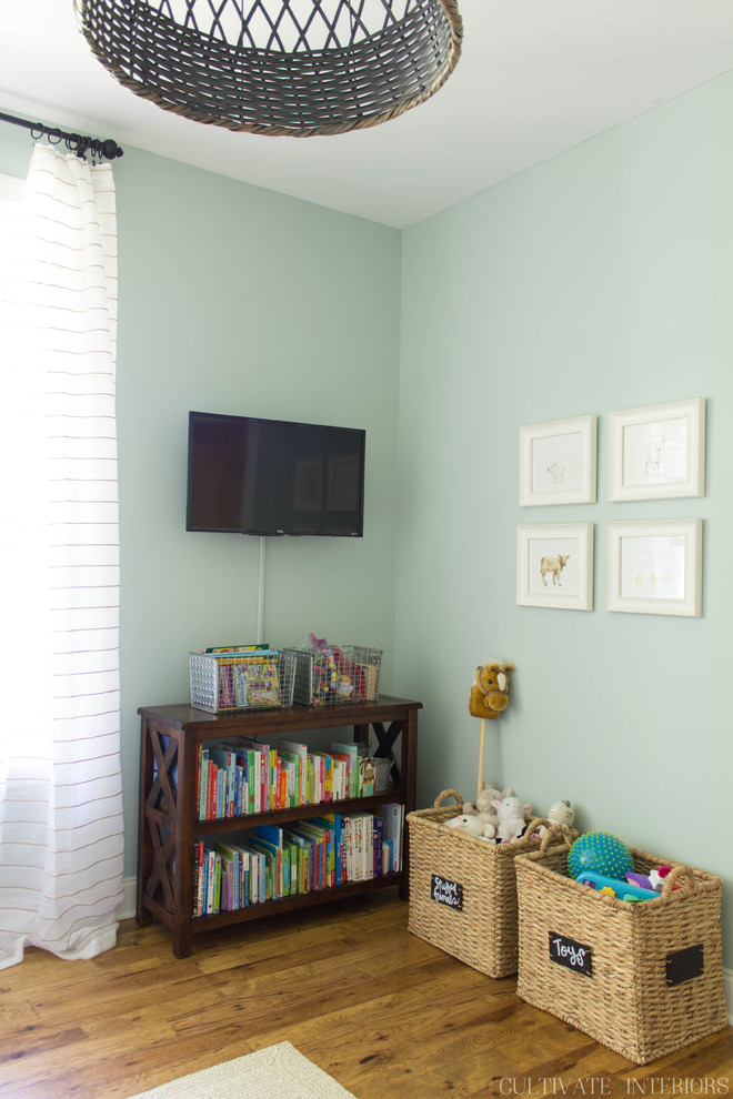 This is an example of a small eclectic kids' room for girls in Other with blue walls and dark hardwood floors.