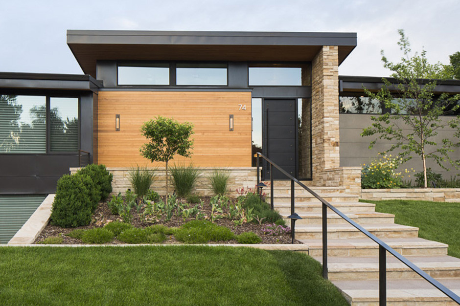 This is an example of a mid-sized modern front door in Denver with beige walls, travertine floors, a single front door, a black front door and beige floor.