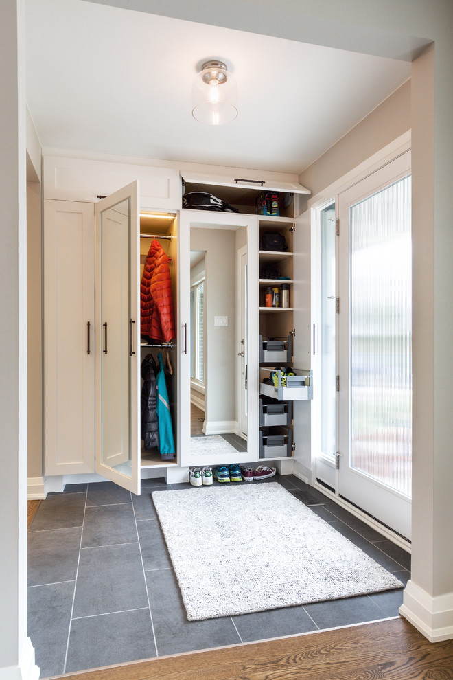 Inspiration for a mid-sized transitional slate floor foyer remodel with gray walls and a glass front door