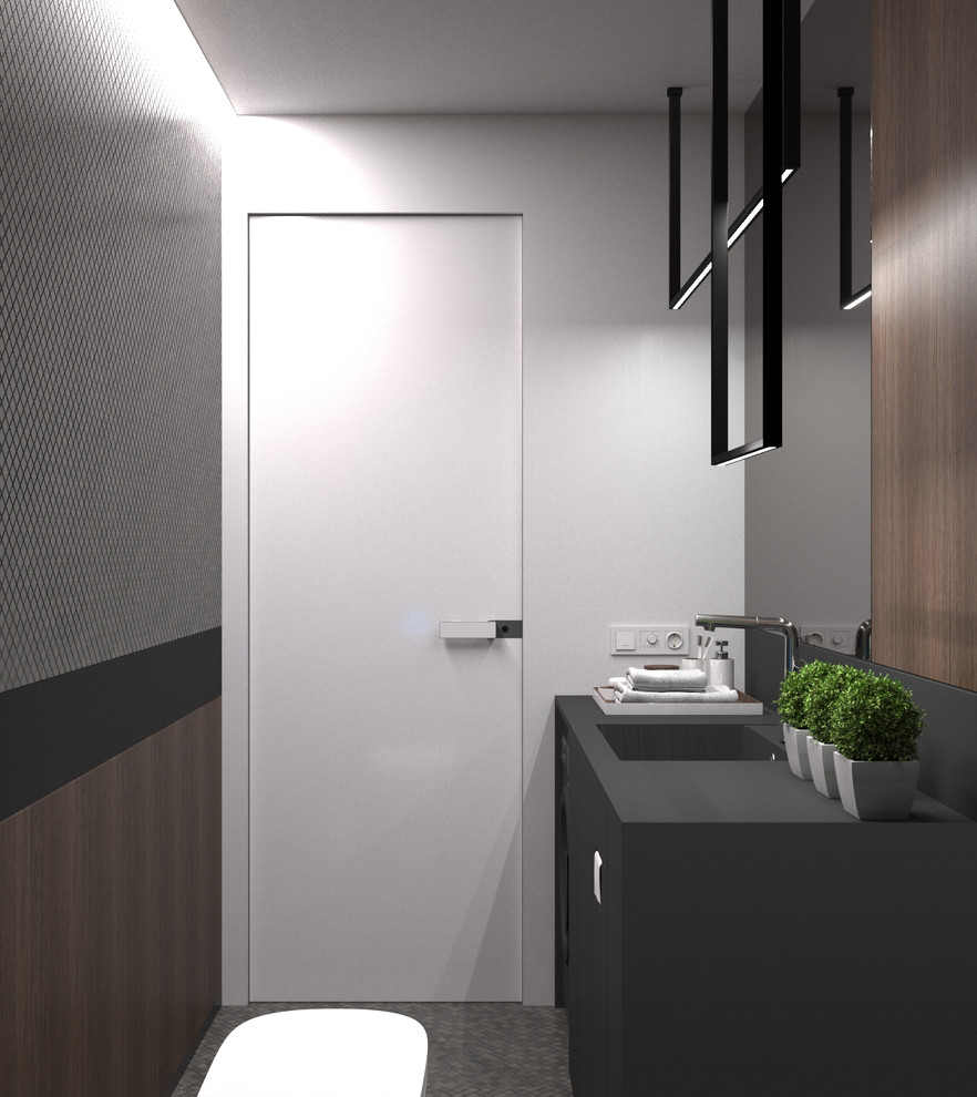 Inspiration for a small contemporary single-wall dedicated laundry room in Saint Petersburg with an integrated sink, flat-panel cabinets, black cabinets, solid surface benchtops, white walls, porcelain floors, an integrated washer and dryer, grey floor and black benchtop.
