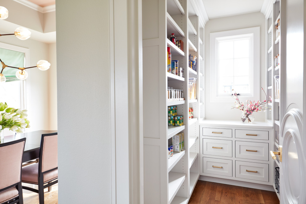 Example of a large transitional l-shaped eat-in kitchen design with recessed-panel cabinets, white cabinets and an island