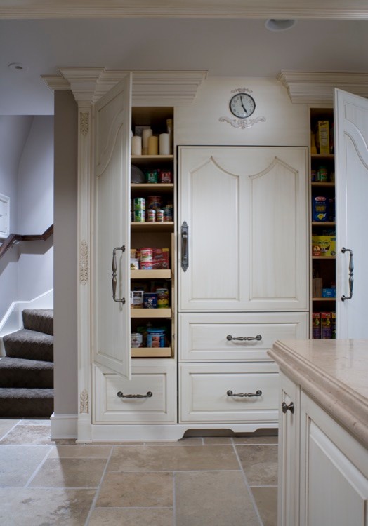 Eat-in kitchen - mid-sized transitional l-shaped travertine floor eat-in kitchen idea in Chicago with a farmhouse sink, raised-panel cabinets, white backsplash, paneled appliances, an island, white cabinets, quartz countertops and porcelain backsplash