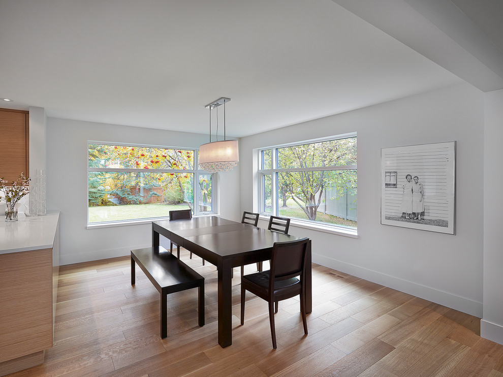 This is an example of a contemporary dining room in Edmonton with white walls.